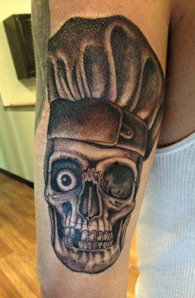 Black Ink Chef Cap On Skull Tattoo On Half Sleeve