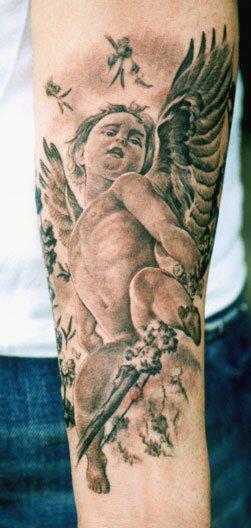 Black Ink Cherub Tattoo On Forearm By Tom Renshaw