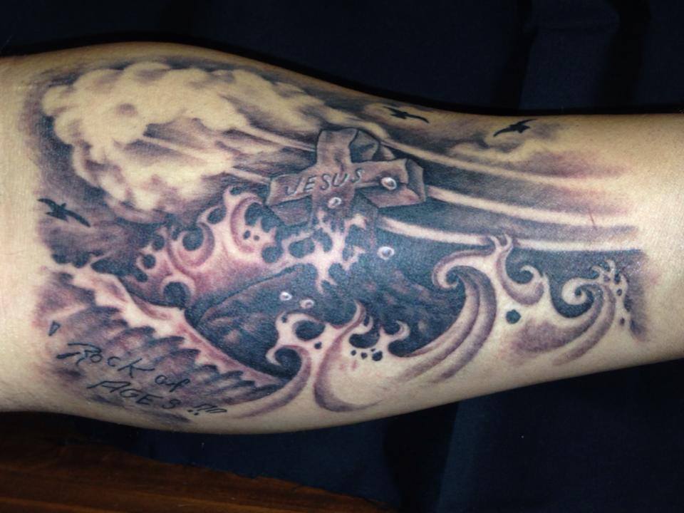 Black Ink Cross In Ocean Tattoo On Forearm By Omar