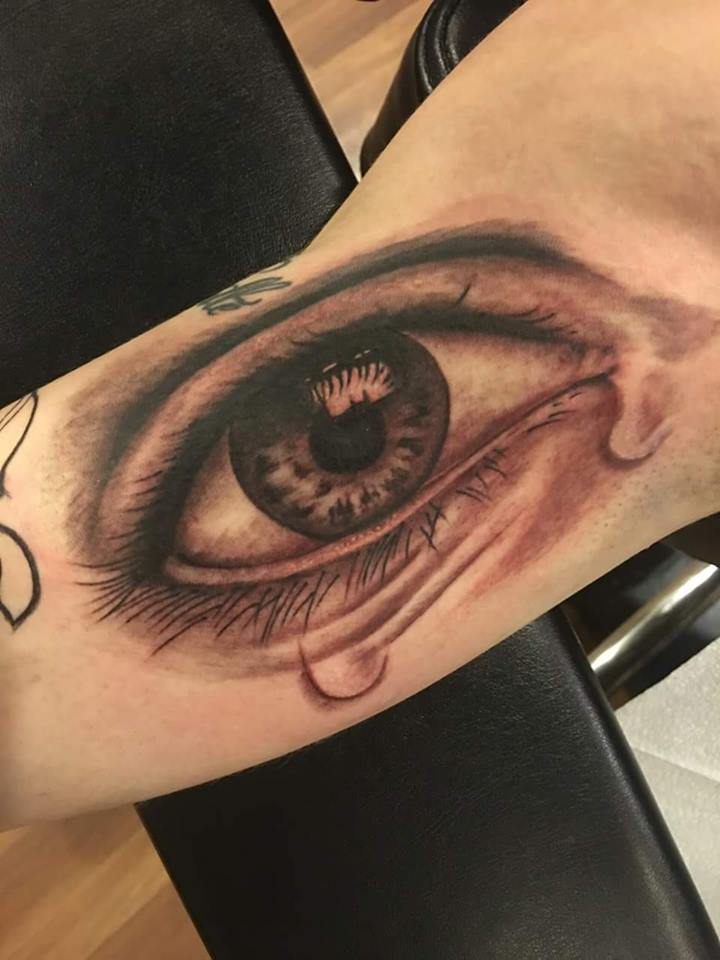 Black Ink Eye Tattoo On Right Bicep By Zak Schulte