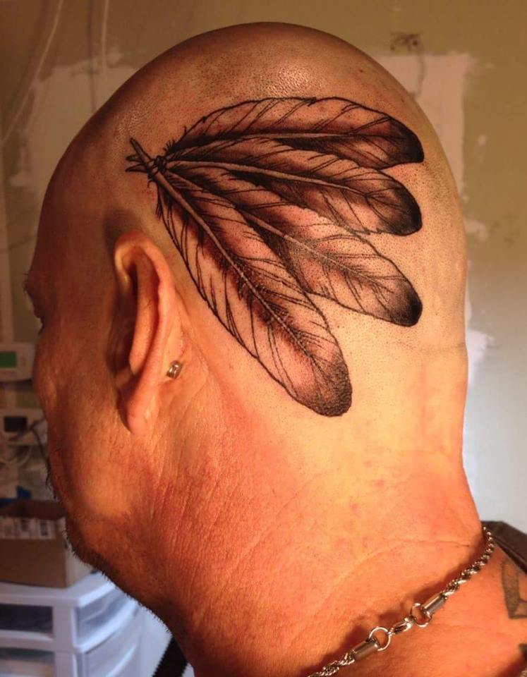 Black Ink Feathers Tattoo On Man Head