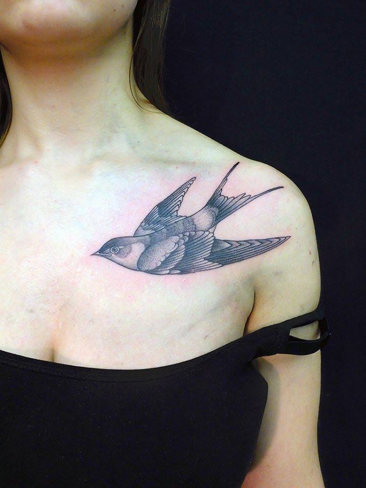 Black Ink Flying Bird Tattoo On Women Left Front Shoulder