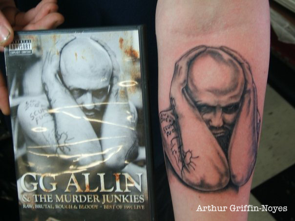 Black Ink GG Allin Tattoo On Forearm