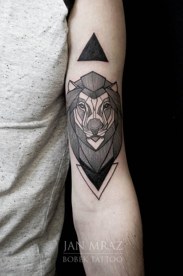 Black Ink Geometric Lion Head Tattoo On Left Bicep