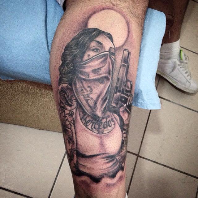 Black Ink Gun In Girl Hand Tattoo On Right Leg