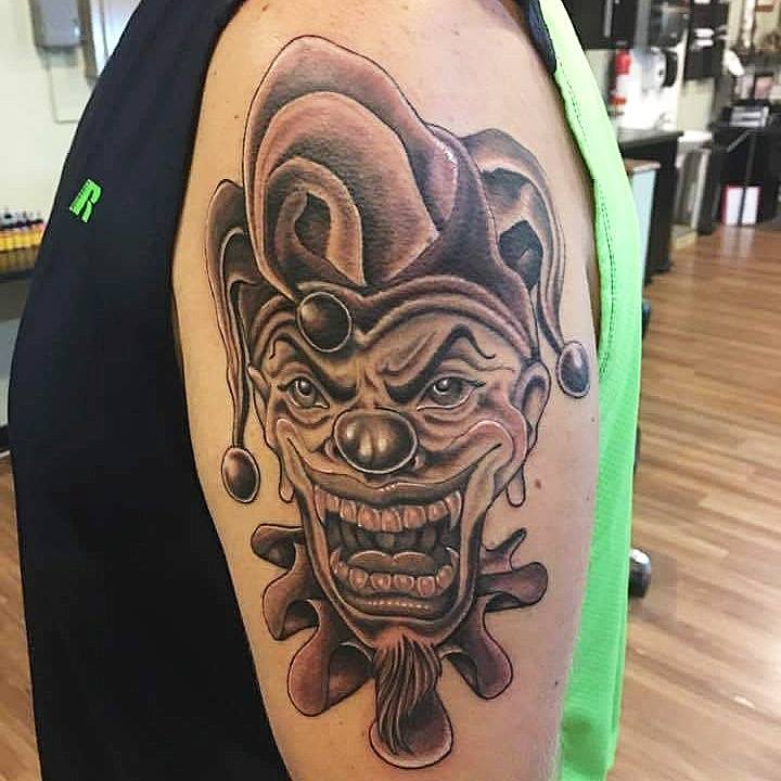 Black Ink Jester Head Tattoo On Left Half Sleeve
