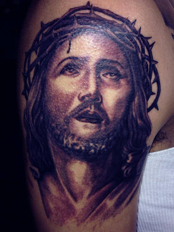 Black Ink Jesus Face Tattoo On Man Right Half Sleeve