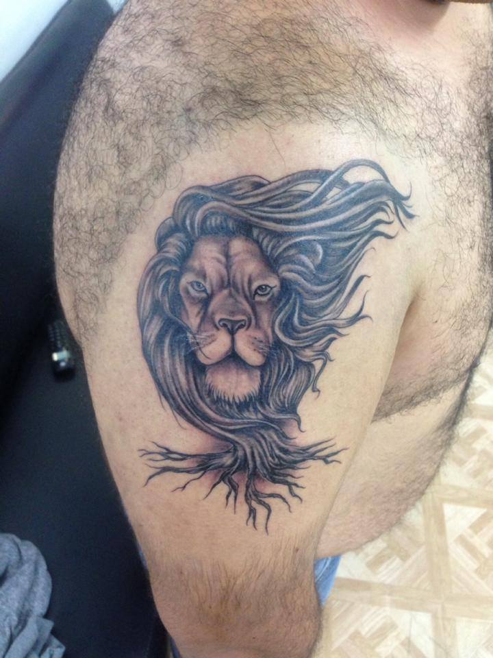 Black Ink Lion Head Tattoo On Man Right Shoulder