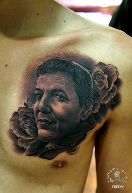 Black Ink Man Face With Roses Tattoo On Man Left Front Shoulder
