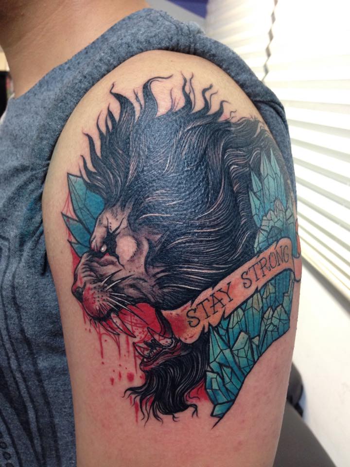 Black Ink Roaring Lion Head With Banner Tattoo On Man Left Shoulder
