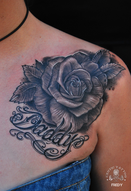 Black Ink Rose Tattoo On Girl Left Front Shoulder