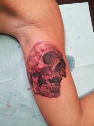 Black Ink Skull Tattoo On Left Bicep