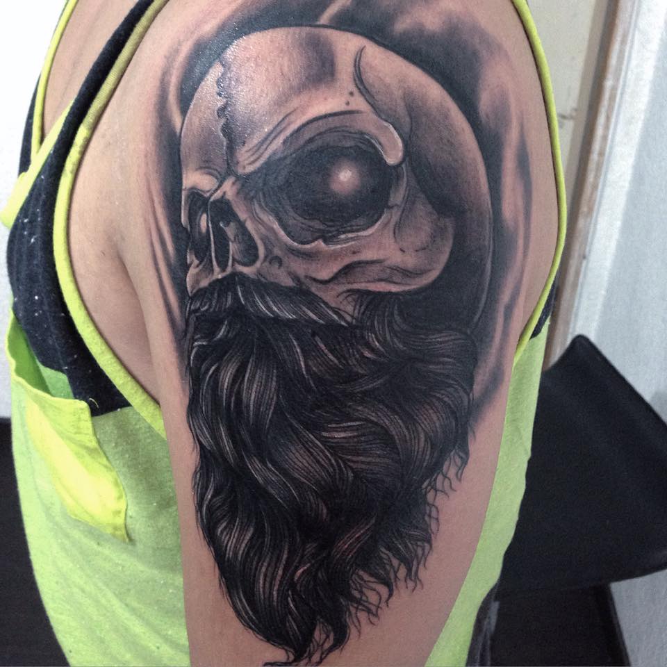 Black Ink Skull With Beard Tattoo On Left Half Sleeve