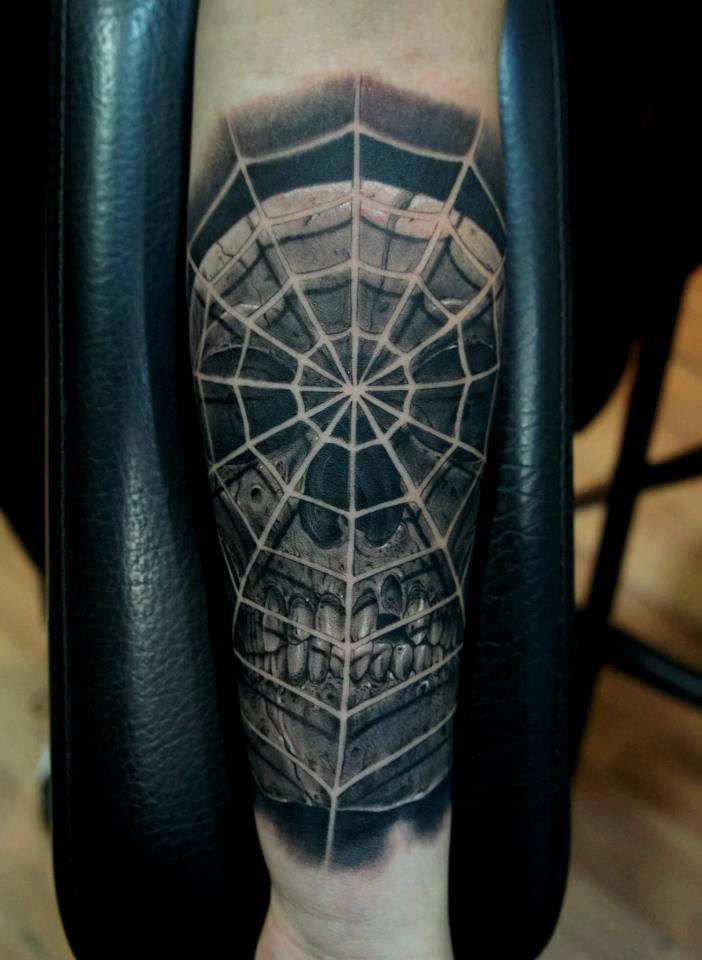 Black Ink Skull With Spider Web Tattoo On Right Forearm