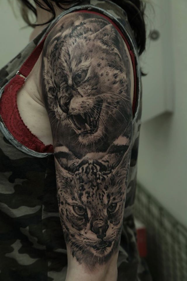 Black Ink Two Cat Face Tattoo On Women Left Half Sleeve By Dmitriy Samohin