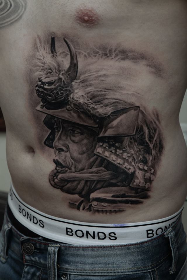 Black Ink Warrior Head Tattoo On Man Stomach By Dmitriy Samohin