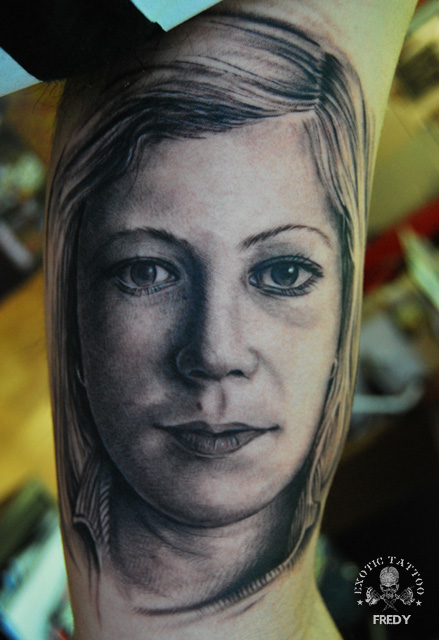 Black Ink Women Face Tattoo On Left Bicep By Fredy