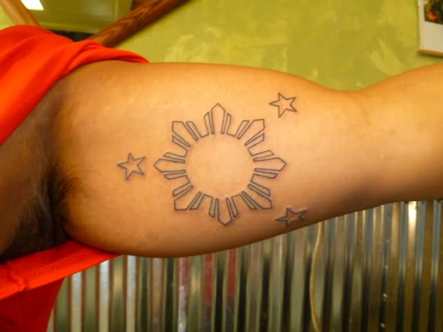 Black Outline Filipino Sun With Stars Tattoo On Left Bicep