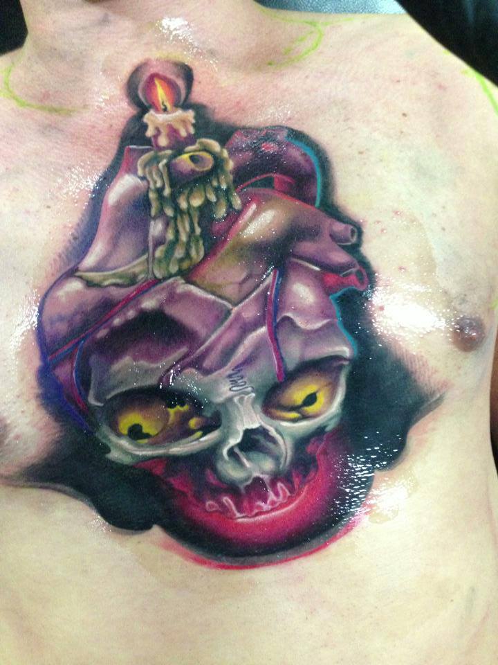 Burning Candle On Real Heart With Skull Tattoo On Man Chest By Fabz