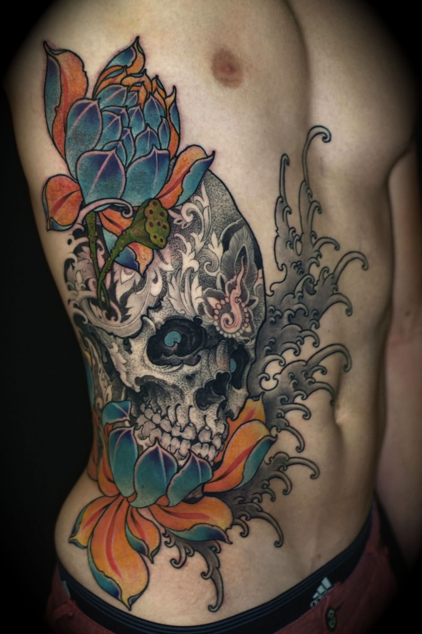 Classic Sugar Skull With Flowers Tattoo On Man Right Side Rib By Ben Merrell