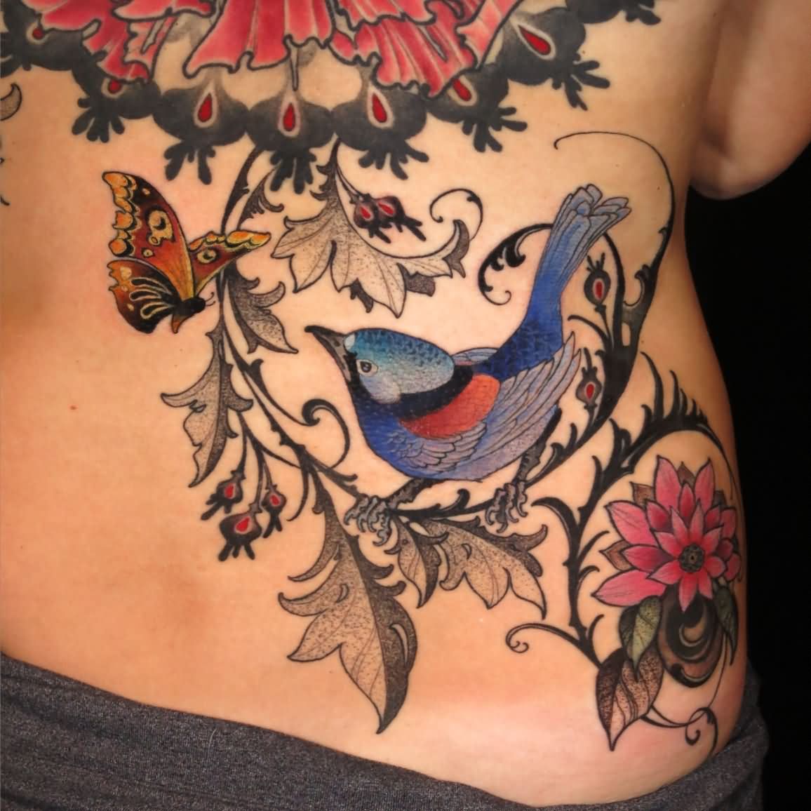 Colorful Bird On Branch With Flying Butterfly Tattoo On Lower Back By Ben Merrell