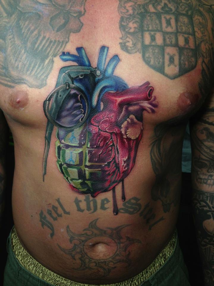 Colorful Grenade Real Heart Tattoo On Man Chest