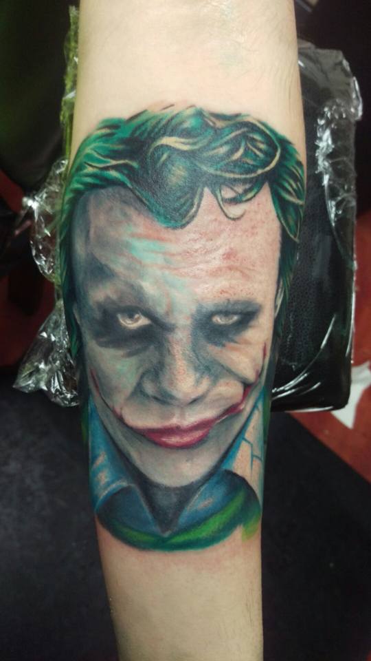 Colorful Joker Face Tattoo On Forearm By Laura Frego