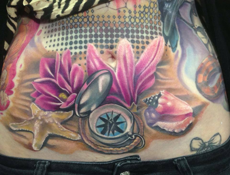 Cool Compass With Star Fish And Flowers Tattoo On Girl Stomach