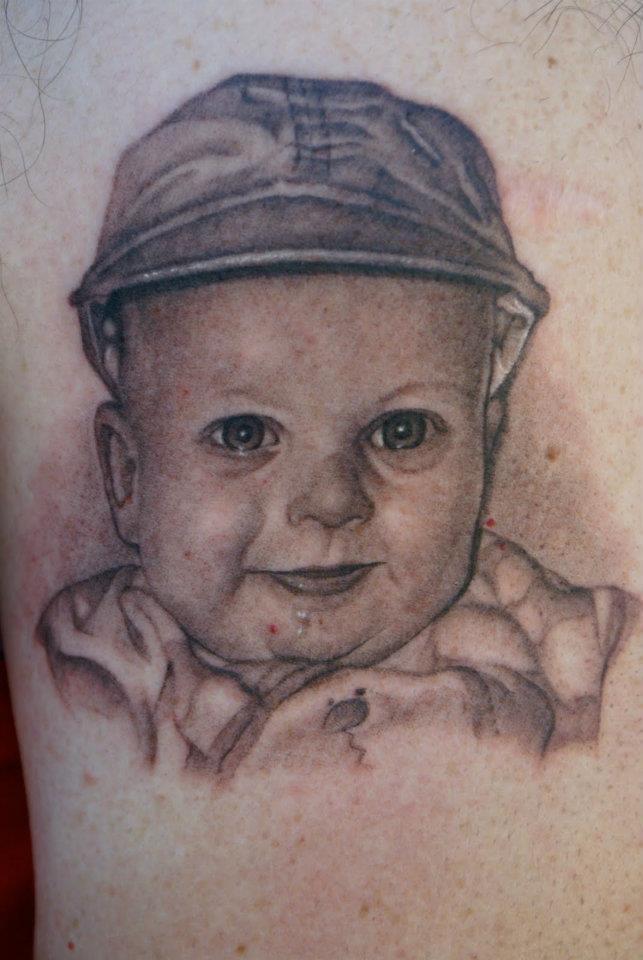 Cute Black Ink Baby Portrait Tattoo Design For Sleeve By Tom Renshaw