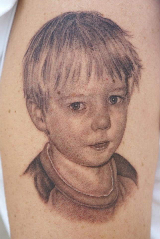 Cute Grey Ink Boy Portrait Tattoo On Sleeve