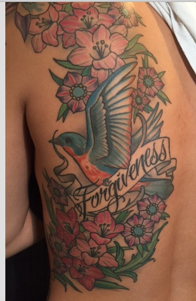Flying Bird With Flowers And Banner Tattoo On Left Back Shoulder By Erick Erickson