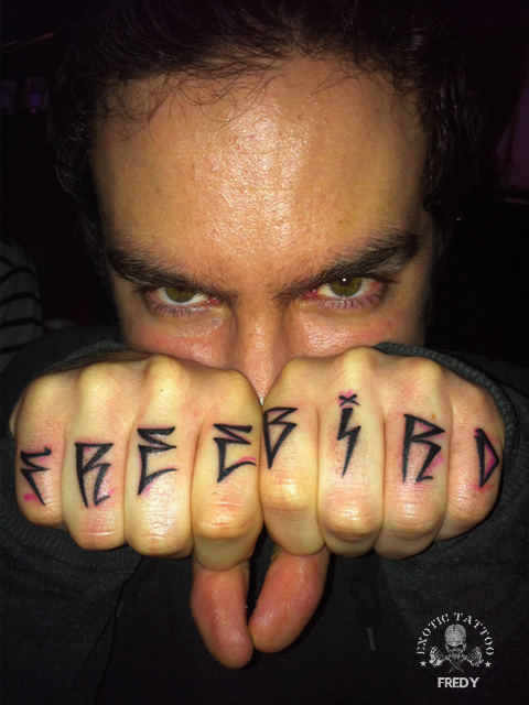 Free Bird Lettering Tattoo On Man Both Hand Fingers