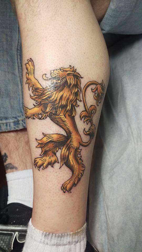 Golden Lion Symbol Tattoo On Left Leg