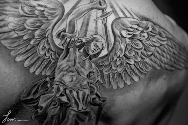 Grey Ink Angel With Dagger Tattoo