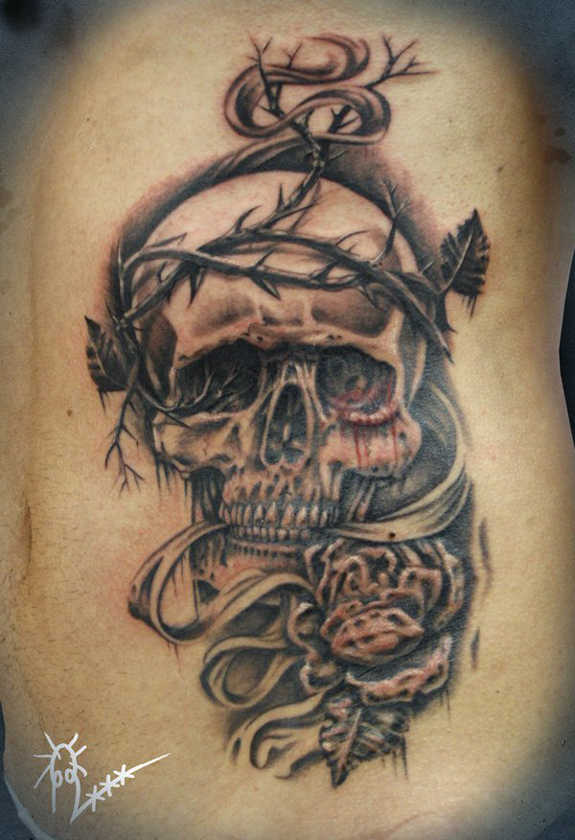 Grey Ink Skull With Thorns Tattoo On Side Rib