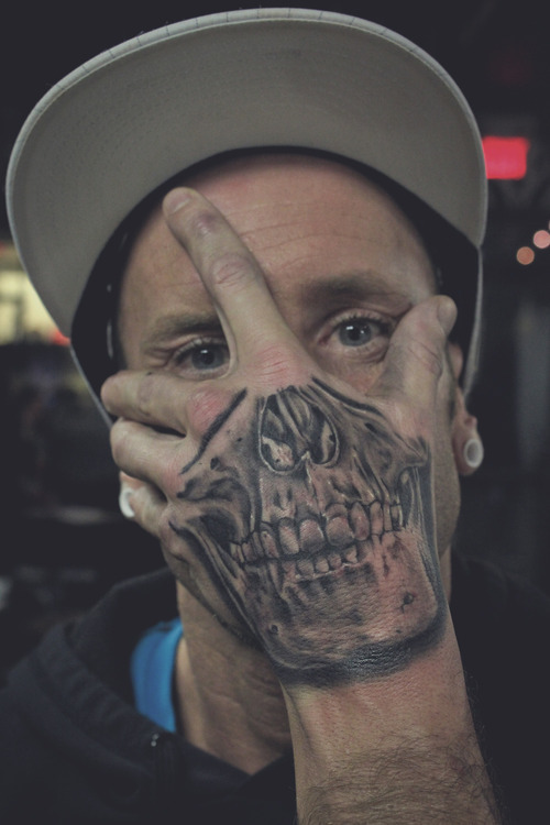 Grey Skull Tattoo On Man Left Hand