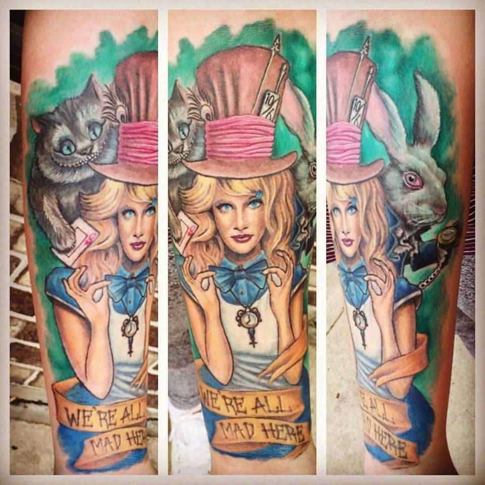 Magician Girl With Cheshire Cat And Banner Tattoo On Right Arm