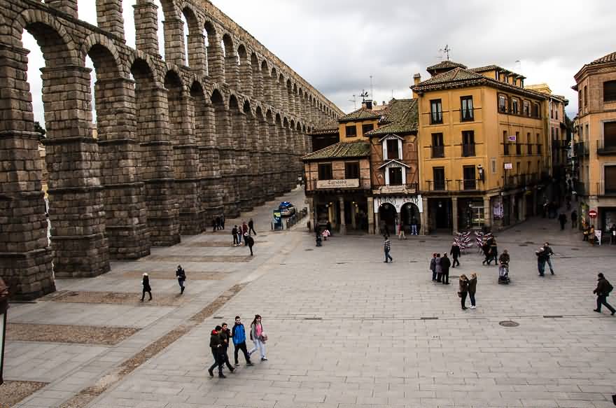 People Walking Near The Aqueduct Of Segovia