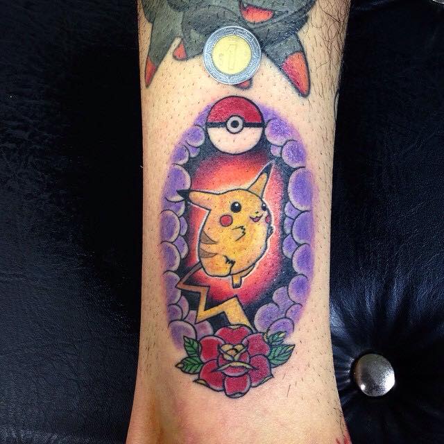 Pikachu With Pokemon Ball And Rose Tattoo On Leg