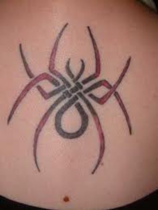 Red And Black Spider Tattoo On Lower Back