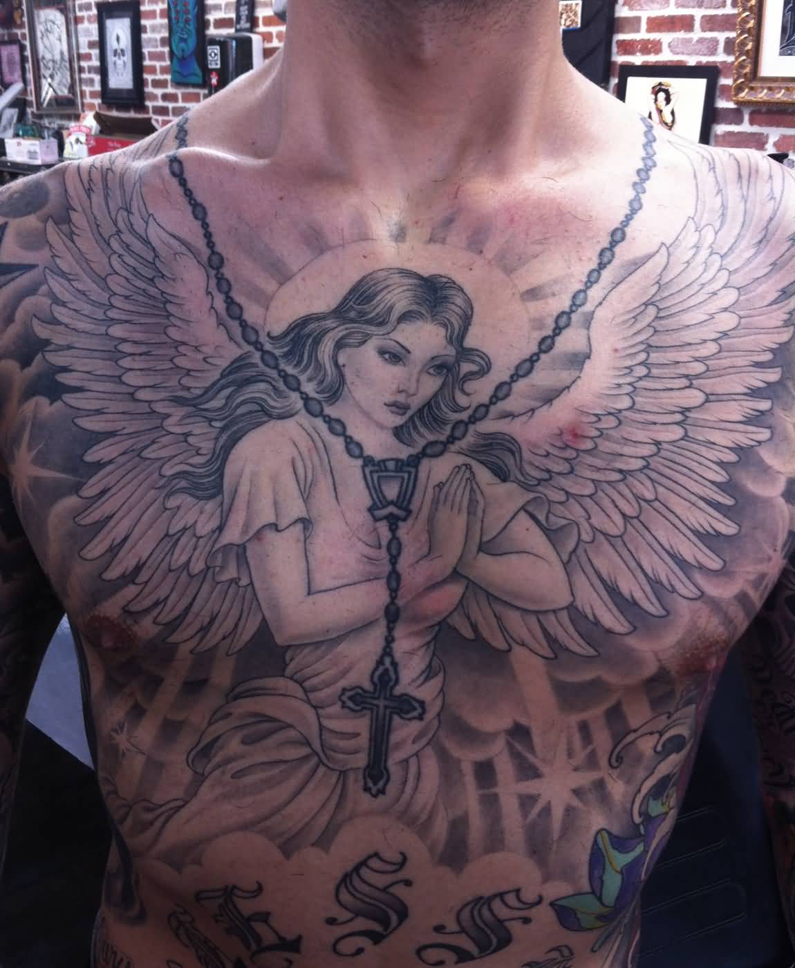 Rosary Cross And Winged Angel Tattoo On Man Chest