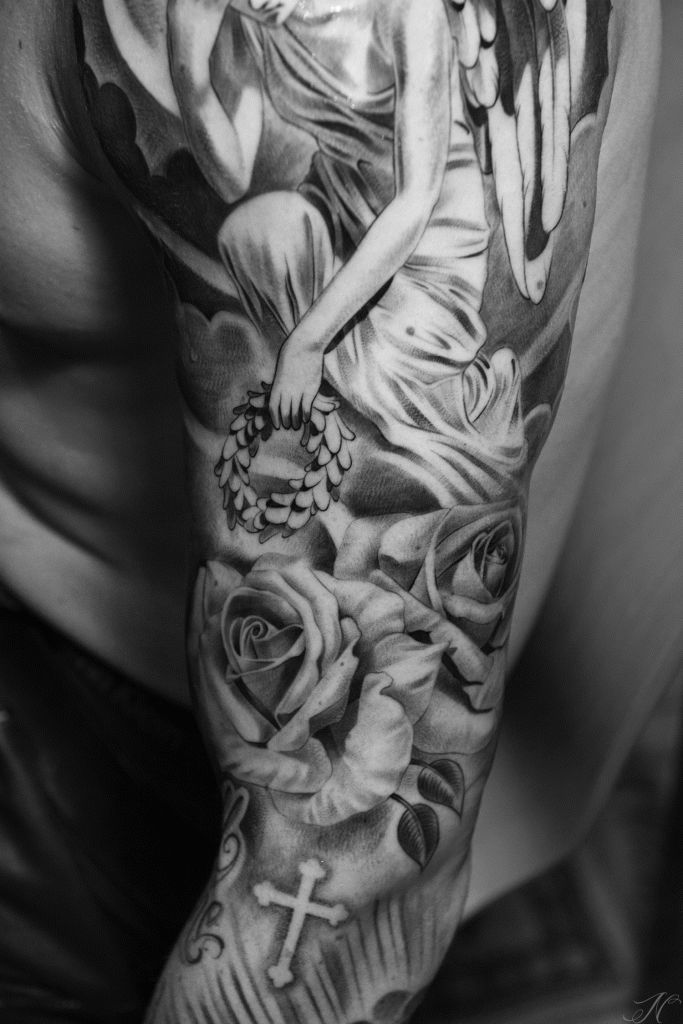 Roses And Angel Tattoo On Man Left Sleeve