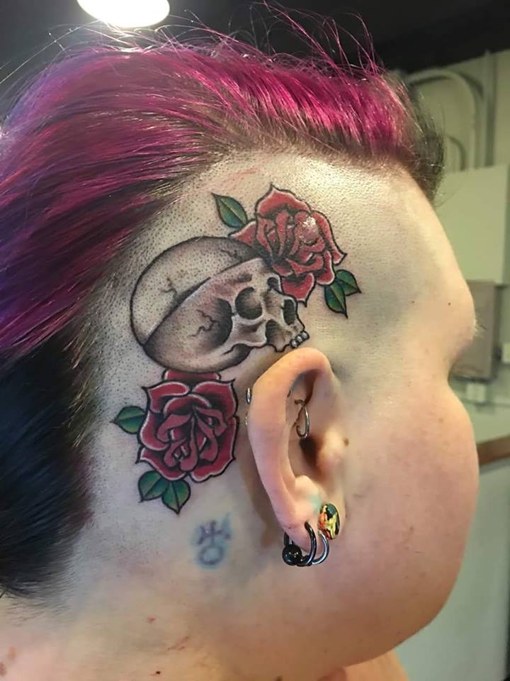 Skull With Roses Tattoo On Women Right Behind The Ear By Zak Schulte