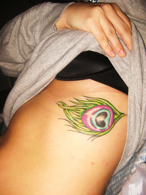 Small Peacock Feather Tattoo On Girl side Rib