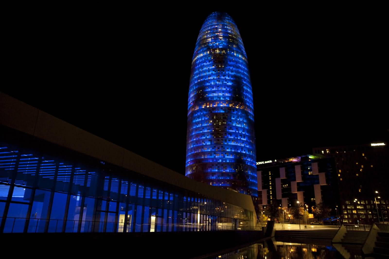 Torre Agbar Illuminated By Night In Barcelona