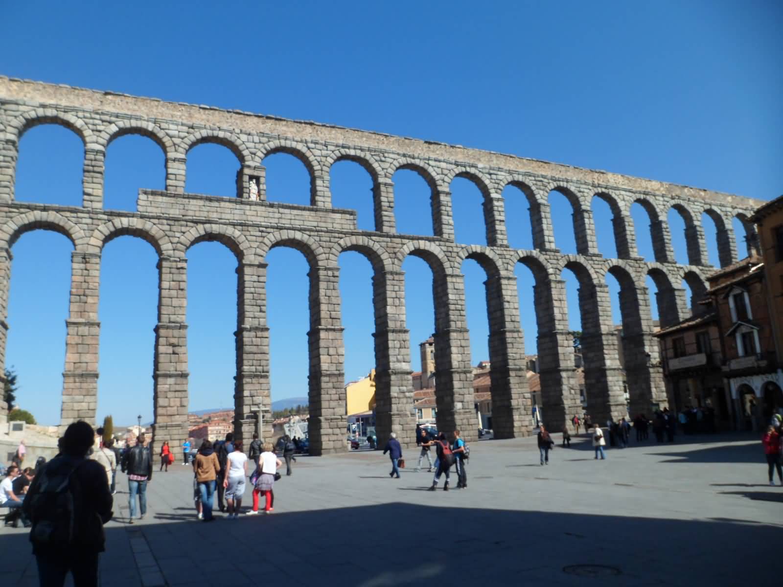 Tourists Enjoying The Sightseeing Of Aqueduct Of Segovia