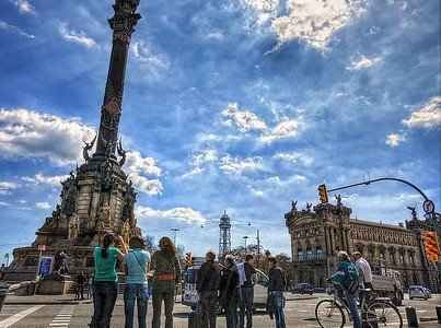 Tourists Enjoying The Sightseeing Of Columbus Monument In Barcelona