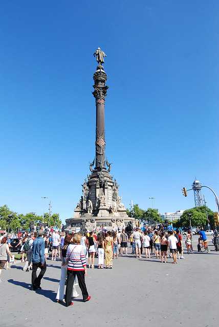 Tourists Enjoying The Sightseeing Of Columbus Monument In Barcelona
