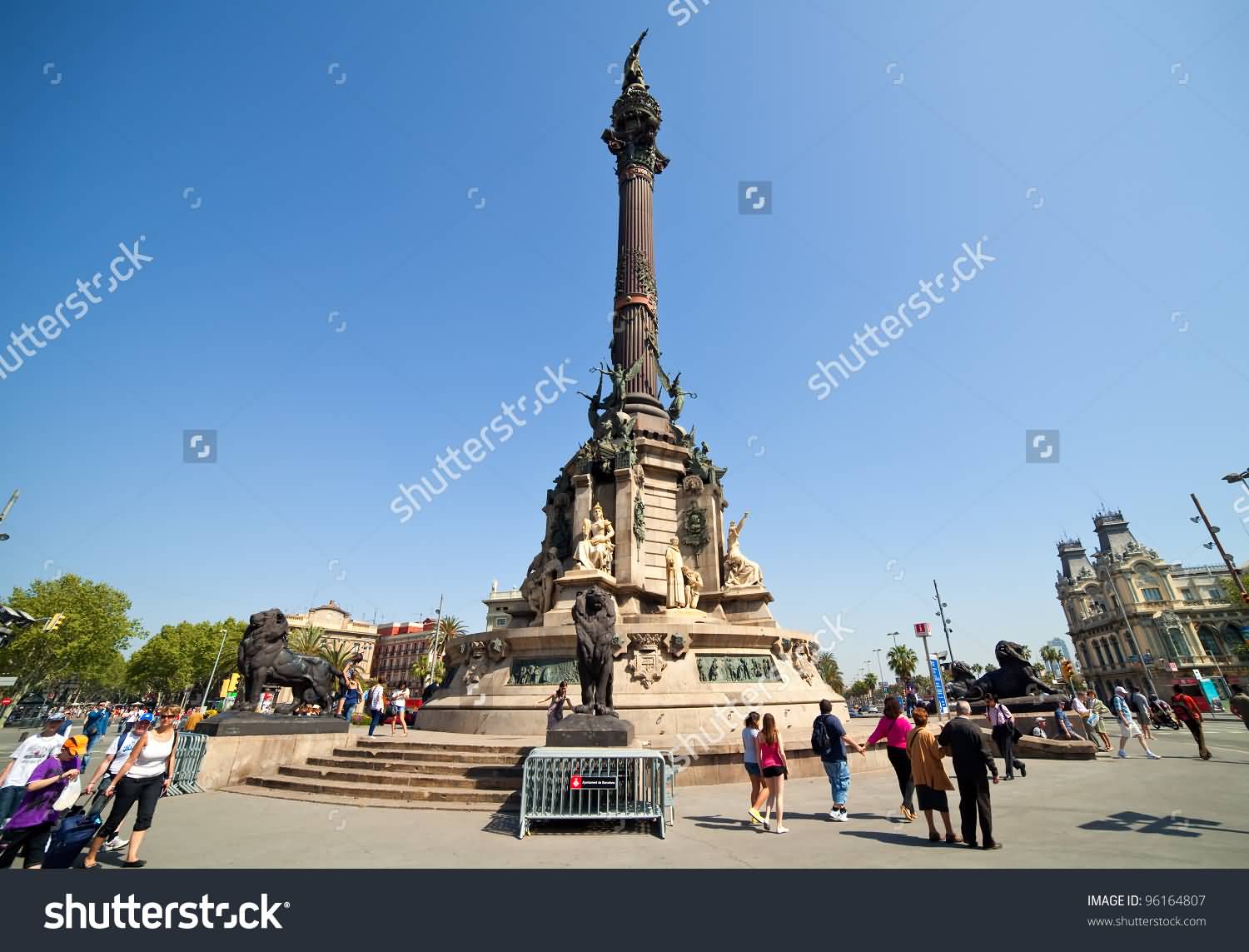 Tourists Walking Near Columbus Monument In Barcelona