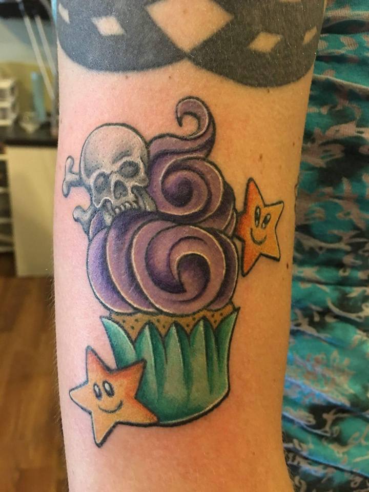 Traditional Cupcake With Danger Skull And Stars Tattoo On Sleeve